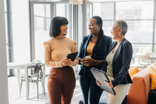 Business women in meeting conversation at digital marketing agency company for empowerment, motivation and tech innovation. Corporate worker people talking of social media trends at informal office