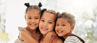 Siblings, boy and girl children hugging and bonding together as a happy family indoors during summer. Portrait of young, cute and beautiful kids smiling, embracing and enjoying their fun childhood