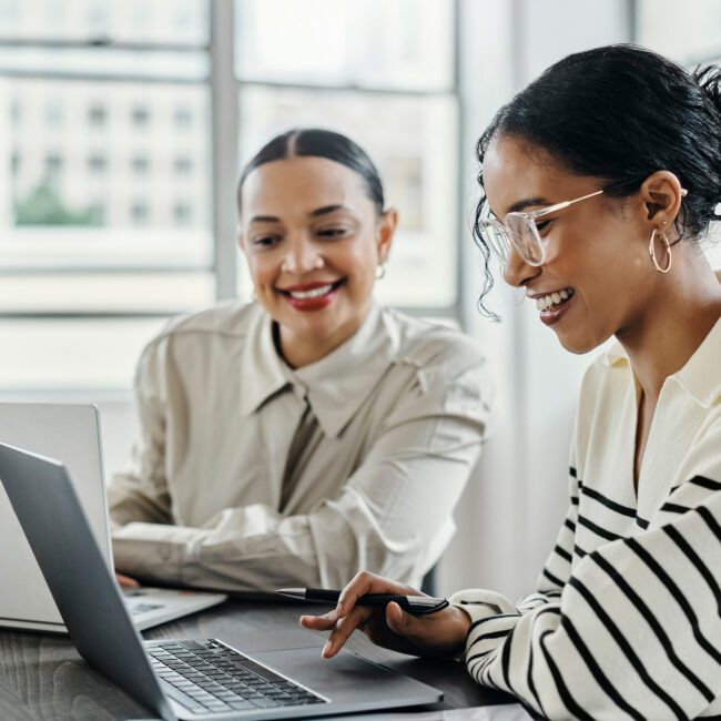 Business women, laptop and and happy team in office for web design, collaboration and training. Planning, digital marketing and coaching by woman leader menor help, explain and support creative goal