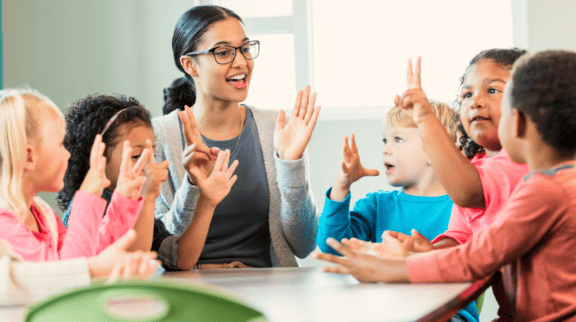 Teacher singing with preschool students